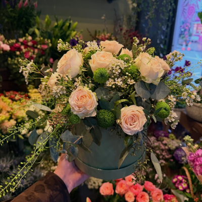 Blush Garden Elegance - Blush Garden Elegance is a refined floral arrangement featuring premium blush roses, delicate white wax flowers, vibrant green button chrysanthemums, and lush eucalyptus foliage, artfully arranged in a stylish hatbox container. The soft pastel palette and natural textures create a timeless, romantic design that suits birthdays, anniversaries, celebrations, sympathy occasions, or simply brightening someone's day. Its elegant garden-inspired style offers a beautiful balance of sophistication and freshness, making it a memorable gift for any occasion.
